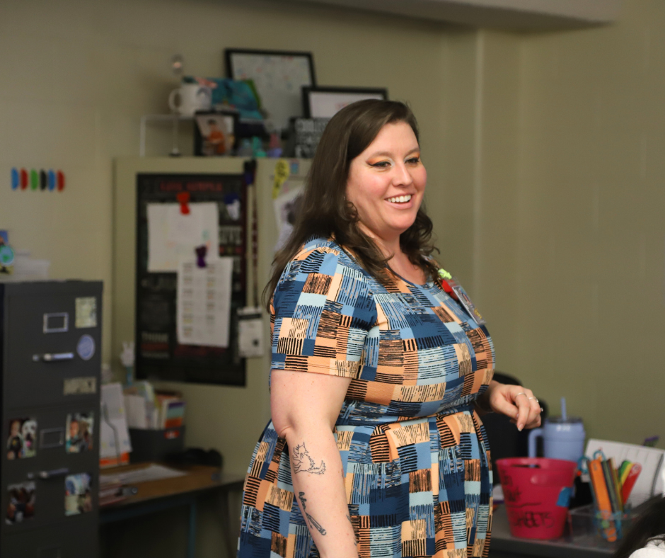Ms. Yager smiling in her classroom talking to students during "Bulldog Time".